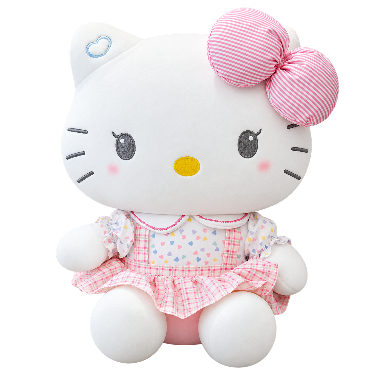 A white Kitty plush with gray embroidered eyes, a pink-and-white striped bow, a pastel heart-pattern top and a pink gingham skirt with ruffle details.