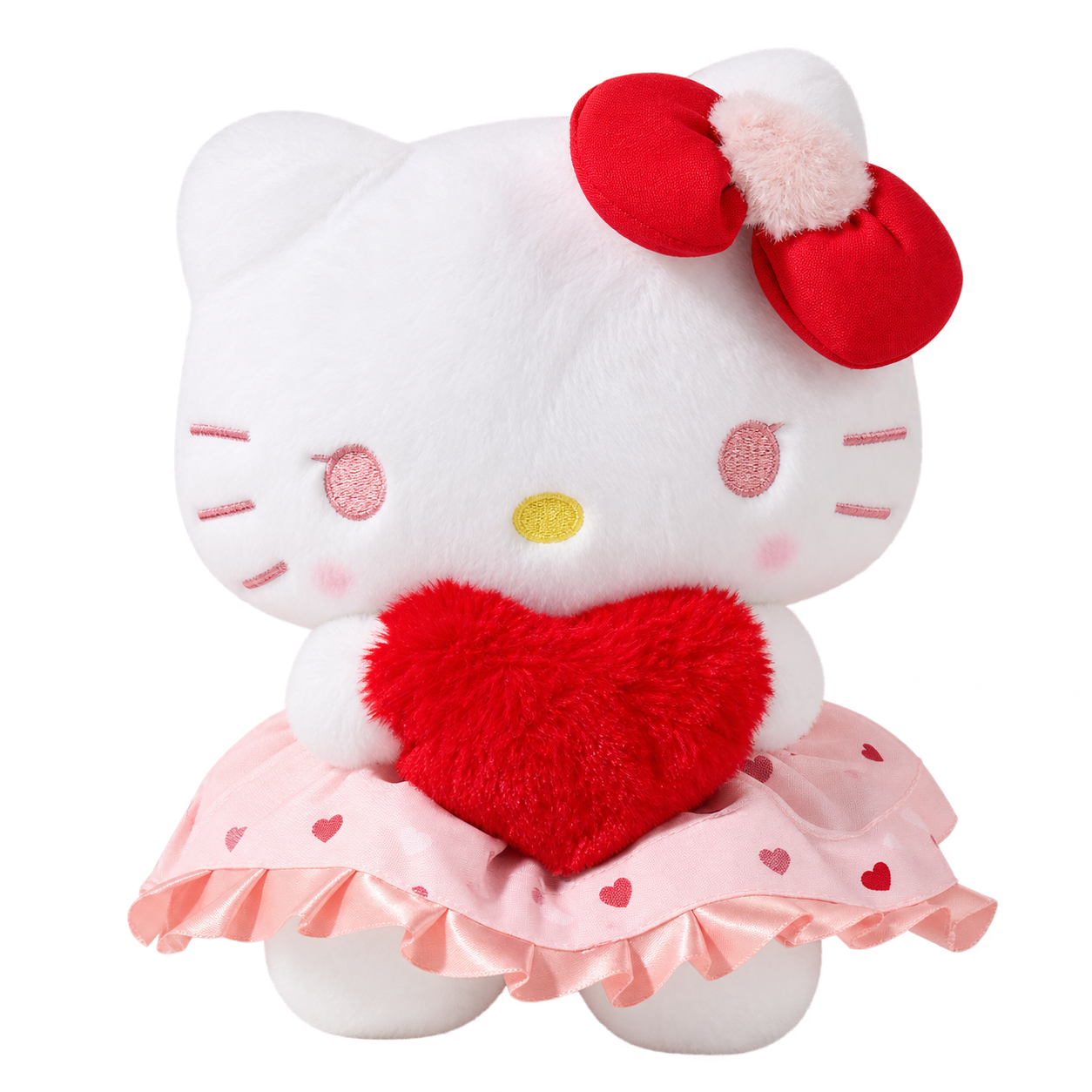 A white Kitty plush holding a red heart, with pale-pink face embroidery, a red bow with a pale fluffy center, and a pink heart-print skirt with ruffle trim.